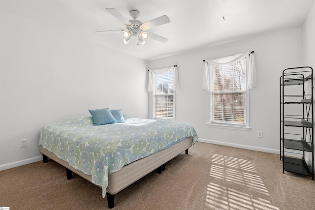 carpeted bedroom featuring a ceiling fan and baseboards