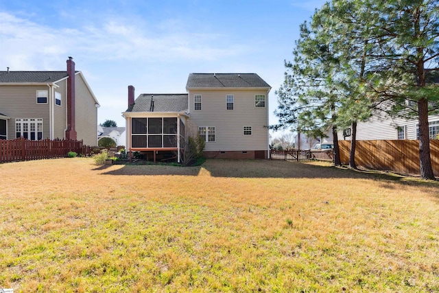 back of property featuring crawl space, a yard, a fenced backyard, and a sunroom