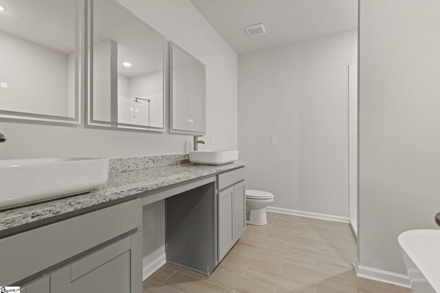 200 Clinkscales Rd Lot 37, Anderson, SC 29624 - bathroom with a shower stall, toilet, baseboards, double vanity, and a freestanding tub