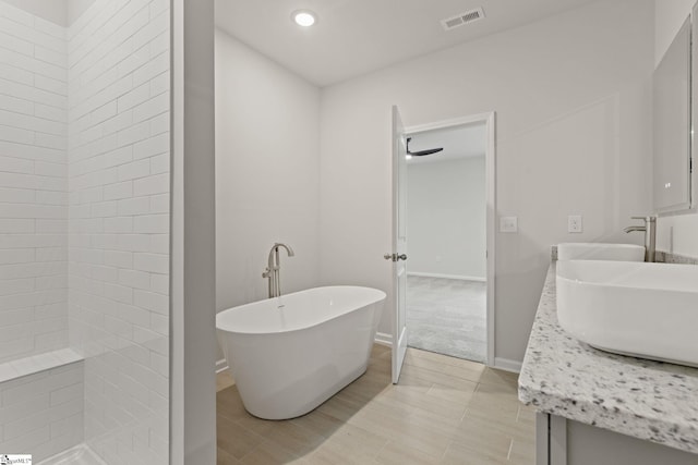 200 Clinkscales Rd Lot 37, Anderson, SC 29624 - bathroom with a soaking tub, double vanity, recessed lighting, and baseboards