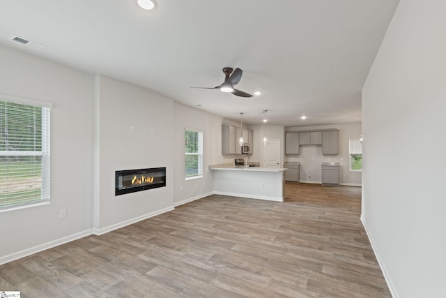 200 Clinkscales Rd Lot 37, Anderson, SC 29624 - unfurnished living room with plenty of natural light, recessed lighting, ceiling fan, and a glass covered fireplace