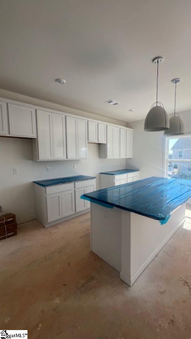 35 Leander Dr, Greer, SC 29651 - kitchen featuring white cabinetry, a kitchen island, pendant lighting, recessed lighting, and baseboards