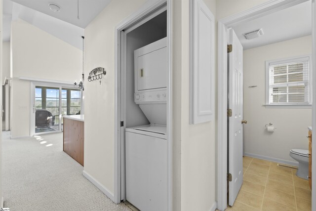 1230 Melton Rd Unit 101, West Union, SC 29696 - laundry area with visible vents, stacked washer and clothes dryer, baseboards, laundry area, and light colored carpet