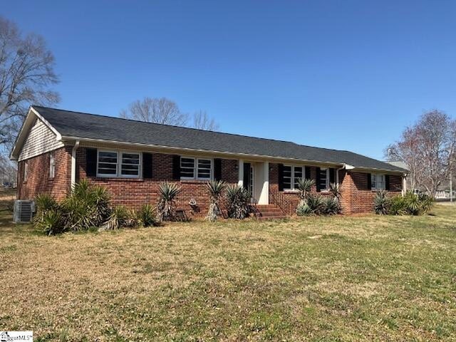 ranch-style home with brick siding and a front yard