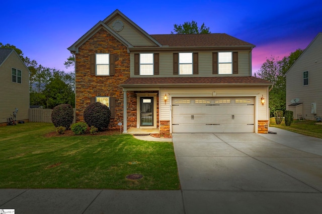 traditional-style house featuring a front yard, an attached garage, stone siding, and concrete driveway
