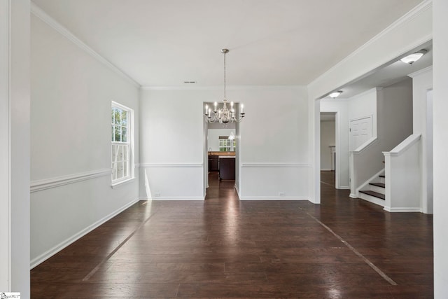 unfurnished dining area featuring ornamental molding, wood finished floors, stairs, a notable chandelier, and baseboards
