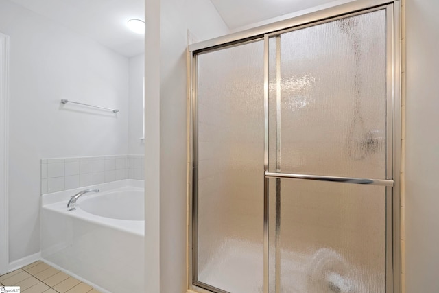 full bathroom featuring a shower stall, tile patterned floors, and a garden tub