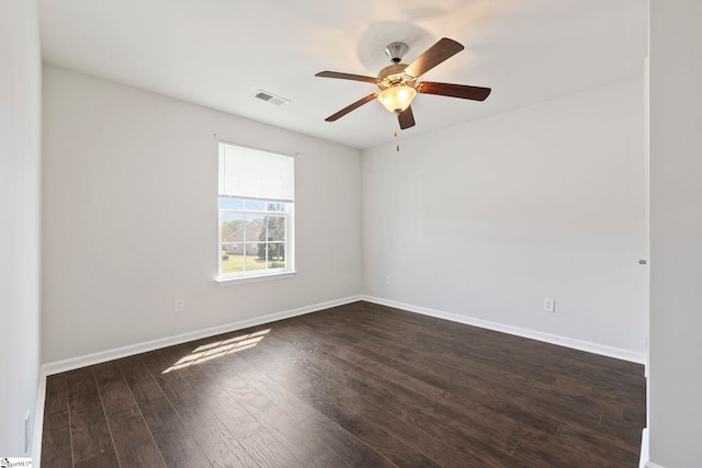 empty room featuring ceiling fan, baseboards, dark wood-style floors, and visible vents