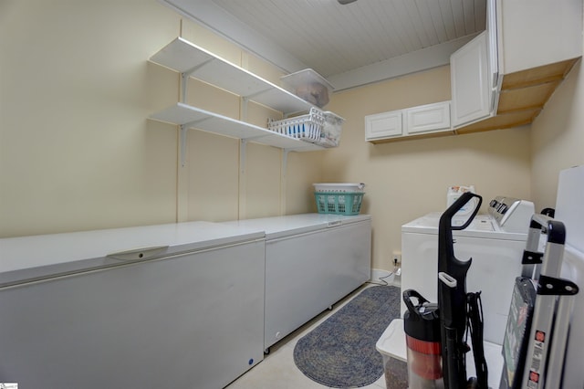 laundry room featuring cabinet space and separate washer and dryer
