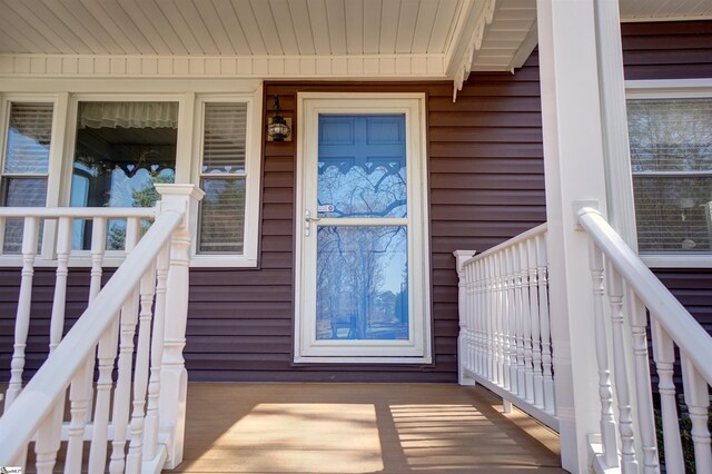 view of exterior entry with a porch