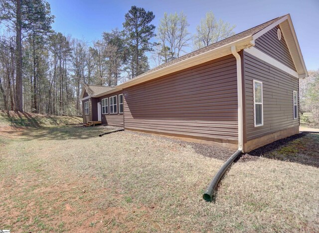 view of property exterior featuring a yard