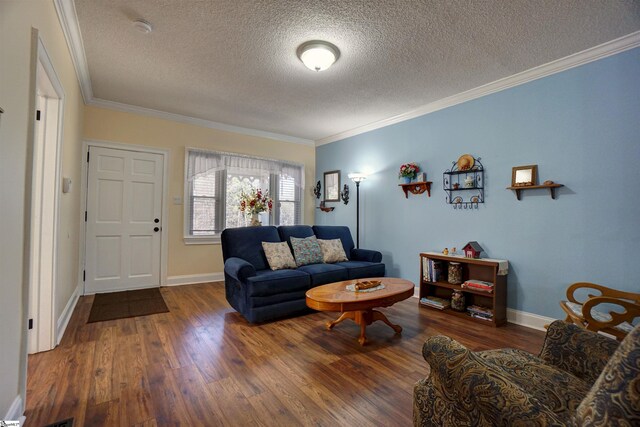 living area with baseboards, a textured ceiling, wood finished floors, and crown molding