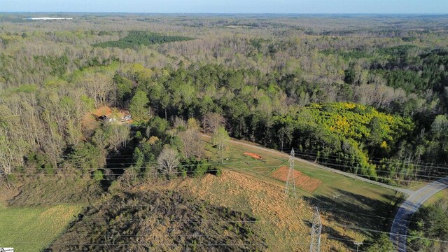 drone / aerial view featuring a wooded view