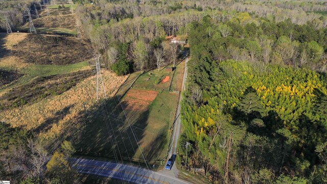 drone / aerial view with a wooded view