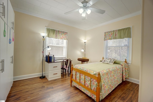 bedroom featuring baseboards, ornamental molding, wood finished floors, and a ceiling fan