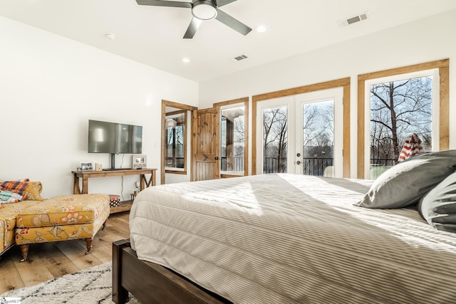 bedroom featuring hardwood / wood-style floors, french doors, access to outside, and visible vents