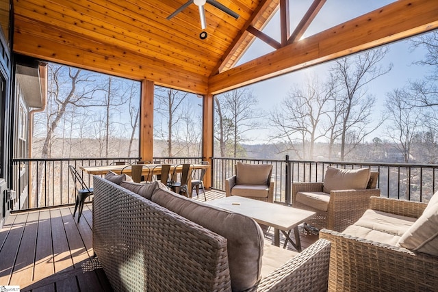 sunroom with a ceiling fan and an outdoor living space