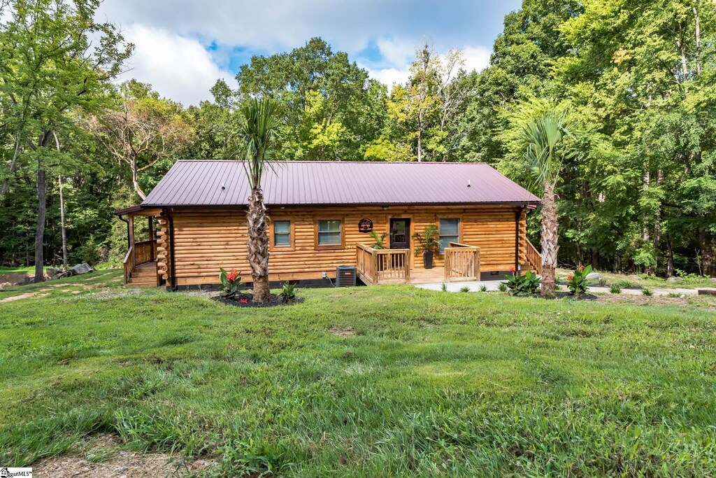 5585 Old Winnsboro Rd, Sc, SC 29055 - view of front facade featuring log siding, metal roof, central air condition unit, and a front lawn