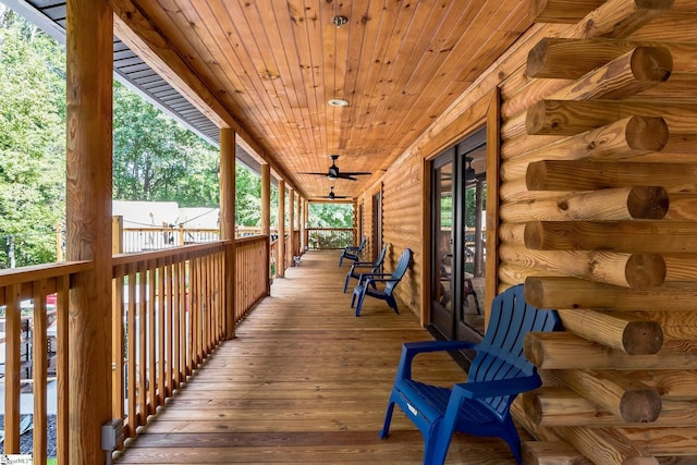 wooden deck with covered porch and a ceiling fan