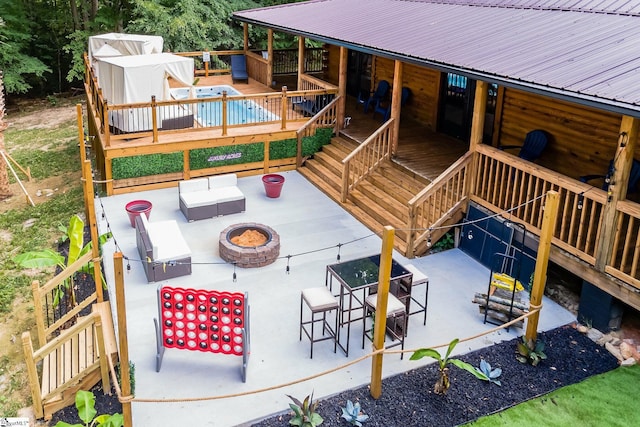 exterior space featuring stairs, an outdoor fire pit, and a patio area