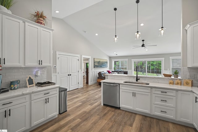kitchen with a sink, ceiling fan, dishwasher, white cabinets, and a peninsula