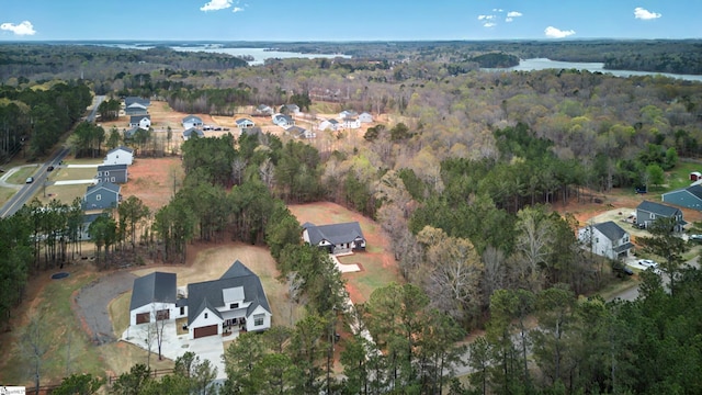 aerial view with a water view and a view of trees