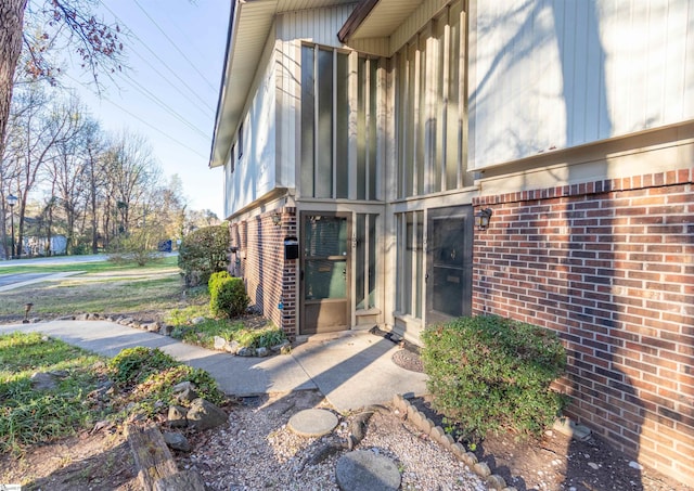 view of exterior entry with brick siding