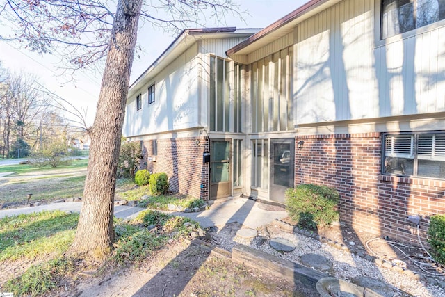 property entrance featuring brick siding