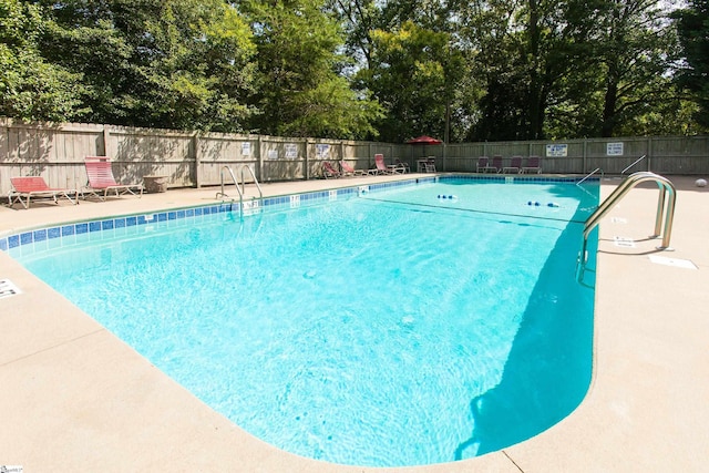 pool featuring a patio and fence