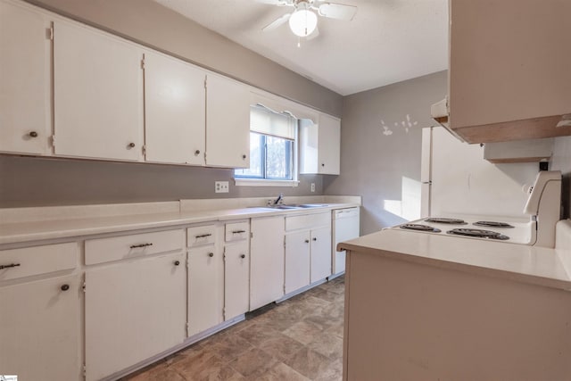 kitchen featuring white appliances, white cabinets, light countertops, and a ceiling fan