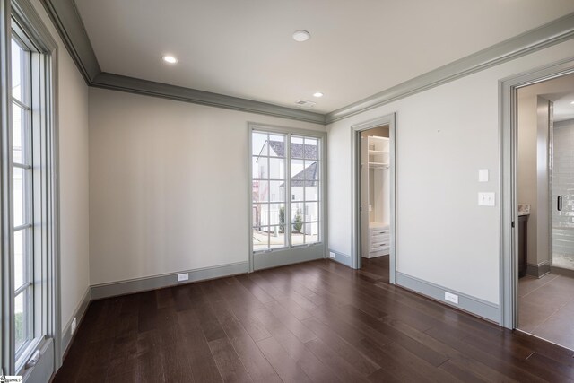 unfurnished bedroom with crown molding, dark wood finished floors, baseboards, visible vents, and recessed lighting