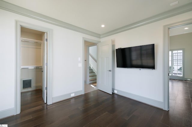 unfurnished bedroom with dark wood-style floors, recessed lighting, baseboards, and ornamental molding