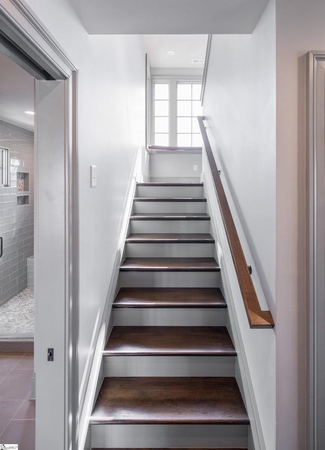staircase with tile patterned floors
