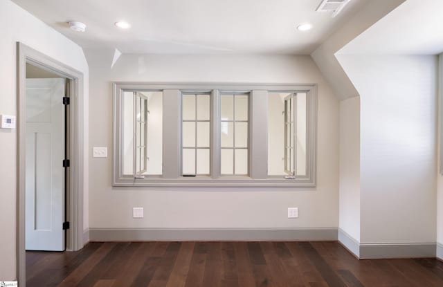 spare room featuring recessed lighting, dark wood-type flooring, baseboards, and visible vents