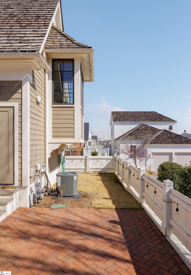 view of patio / terrace with central air condition unit and a fenced backyard