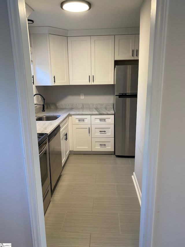 kitchen featuring a sink, white cabinets, and appliances with stainless steel finishes