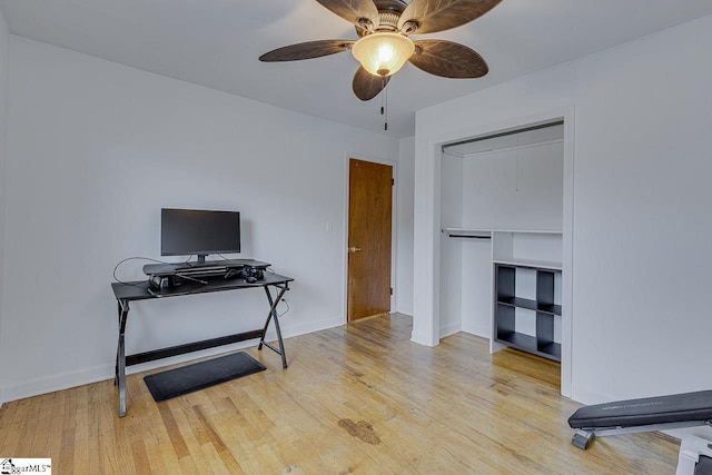 interior space with baseboards, ceiling fan, and wood finished floors