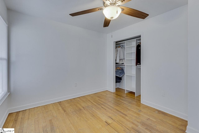 unfurnished bedroom with light wood finished floors, baseboards, a closet, and a ceiling fan