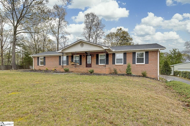 ranch-style house featuring a front lawn and brick siding