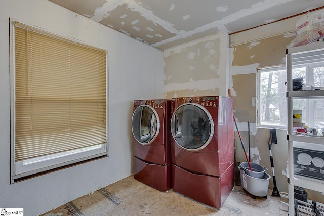 clothes washing area with washing machine and dryer and laundry area