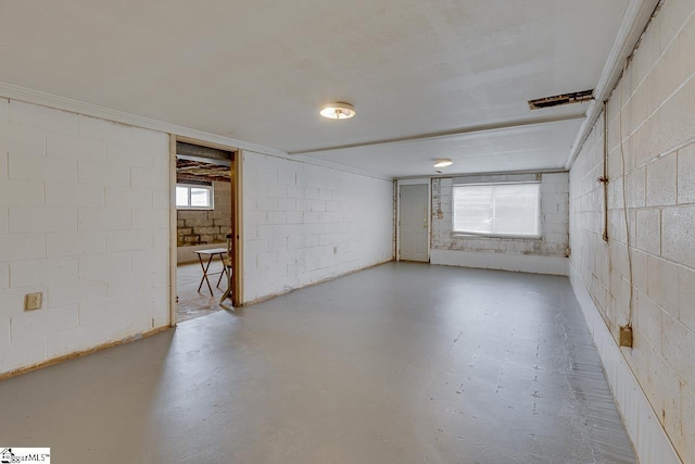 below grade area with concrete block wall and a healthy amount of sunlight