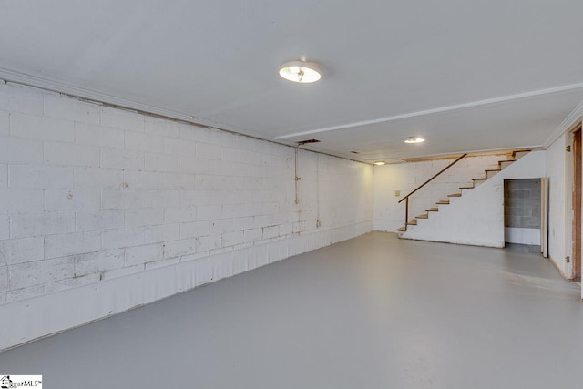 finished below grade area with concrete block wall and stairway