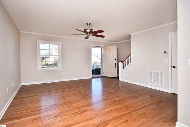 interior space featuring a ceiling fan, visible vents, stairway, and light wood-type flooring