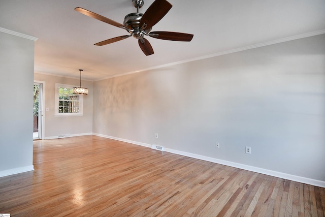 unfurnished room with baseboards, ornamental molding, visible vents, and light wood-type flooring