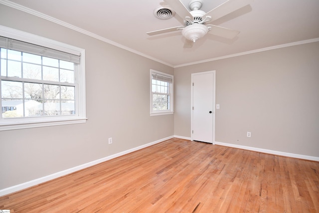 unfurnished room featuring light wood-style flooring, ornamental molding, baseboards, and visible vents