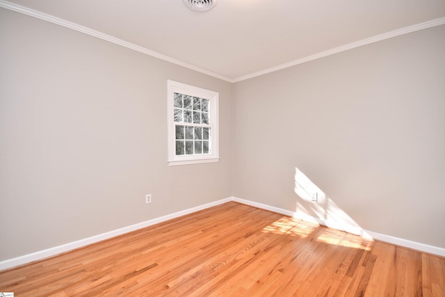 unfurnished room featuring baseboards, visible vents, crown molding, and light wood-type flooring