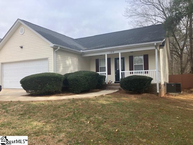 ranch-style house with concrete driveway, central air condition unit, a front yard, covered porch, and a garage