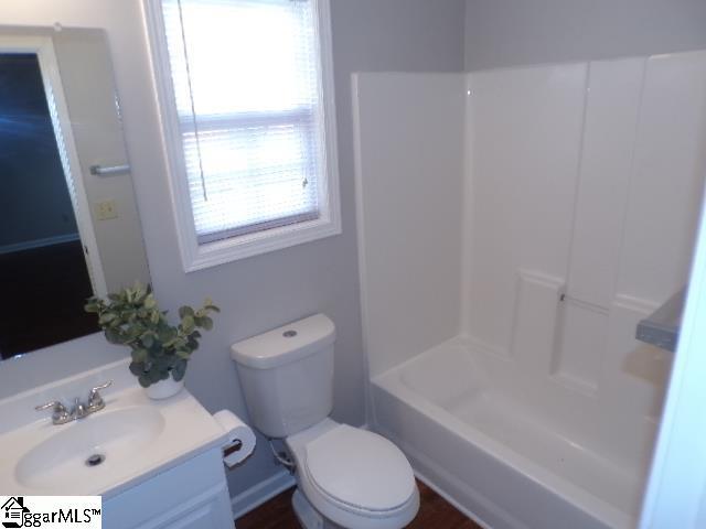 bathroom featuring toilet and vanity