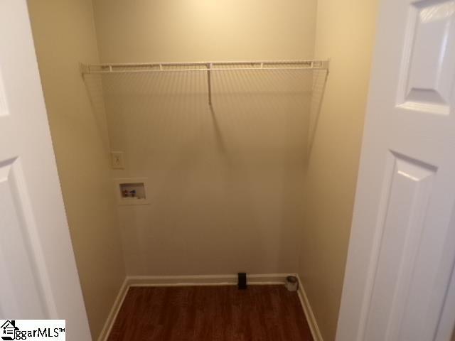laundry area with washer hookup, dark wood-style floors, baseboards, and laundry area