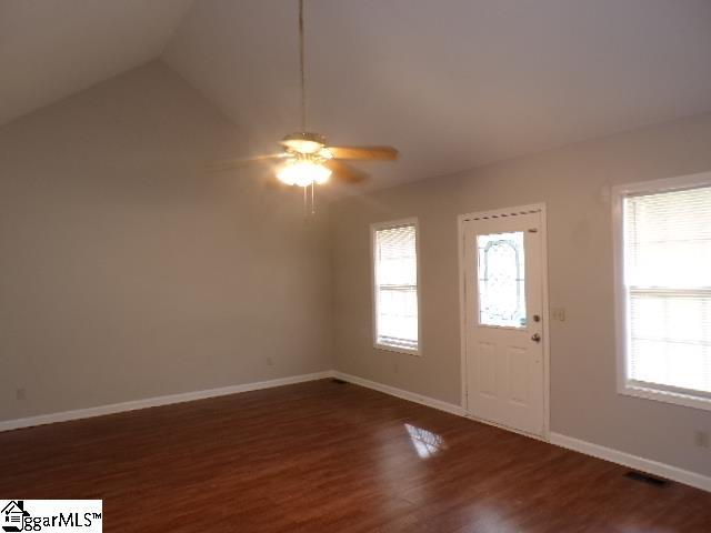 entrance foyer featuring plenty of natural light, baseboards, wood finished floors, and a ceiling fan